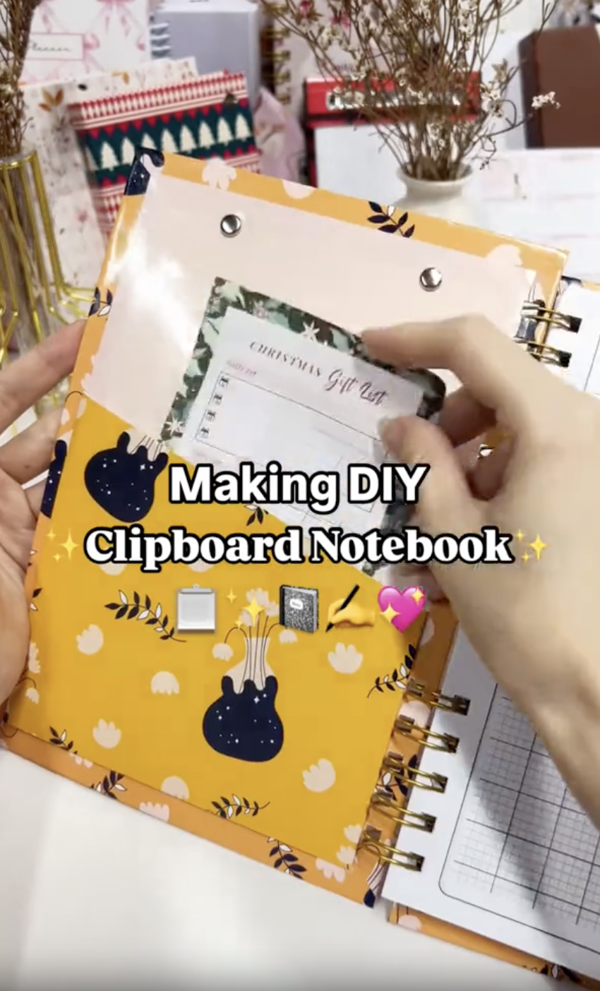 Finished DIY clipboard notebook with wire binding and a clip on the front cover
