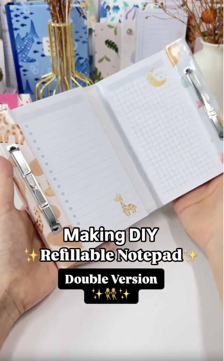 Finished DIY double refillable notepad open with two fastener-bound sections