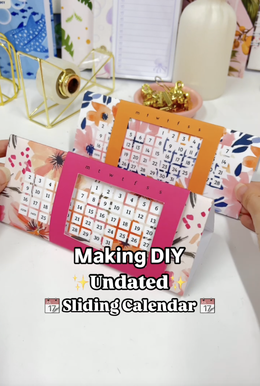 Finished DIY sliding calendar standing as a paper triangle on a desk