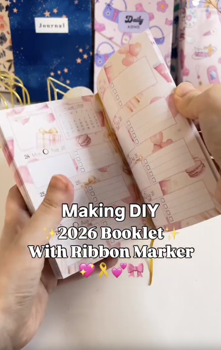 Finished DIY planner booklet with a soft printed cover and bookmark ribbon