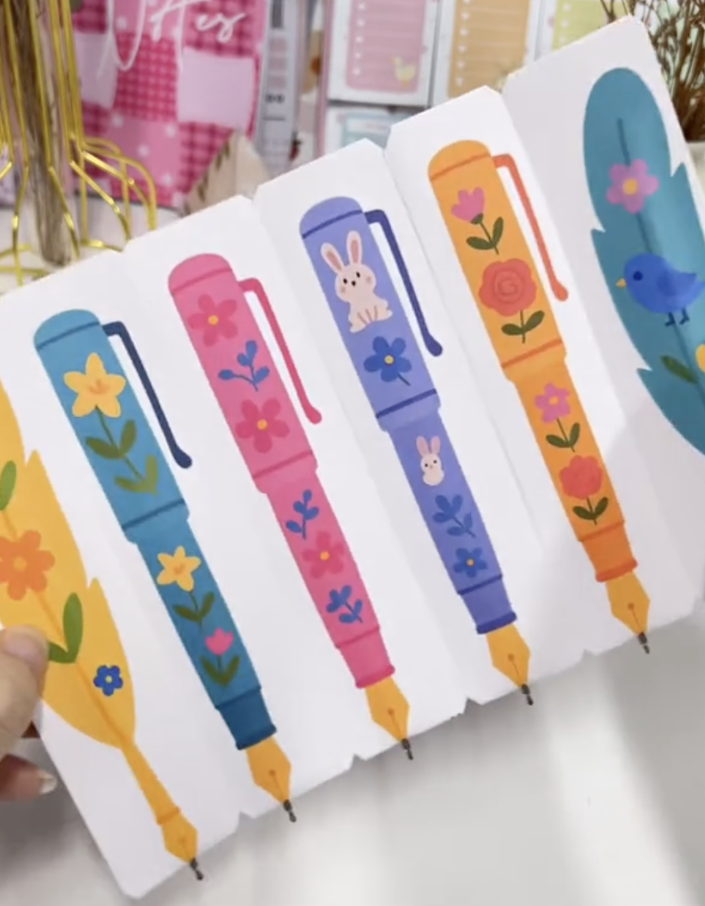 Completed DIY bookmark pens with perforated tear-off sections